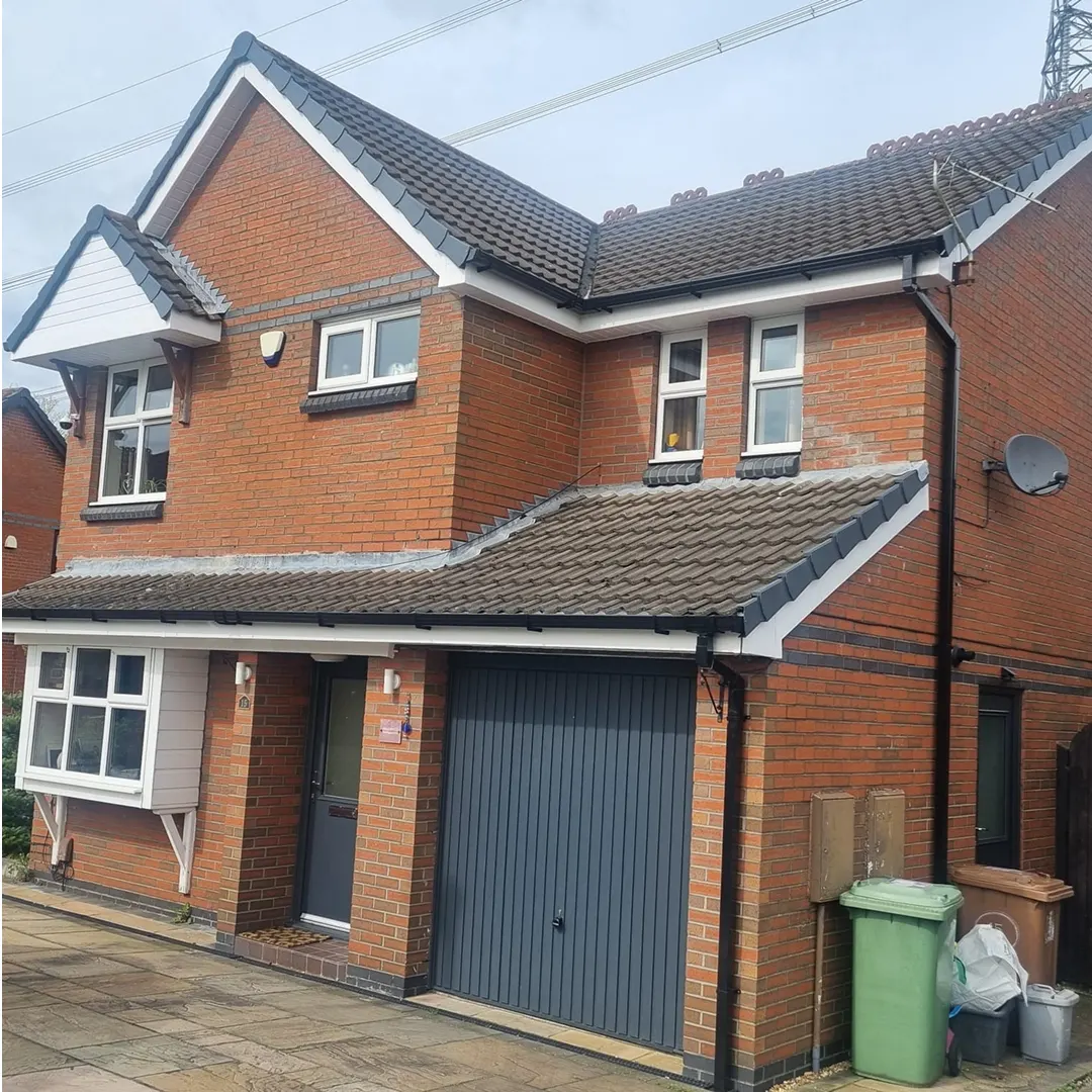 White windows and grey garage door on a detached home