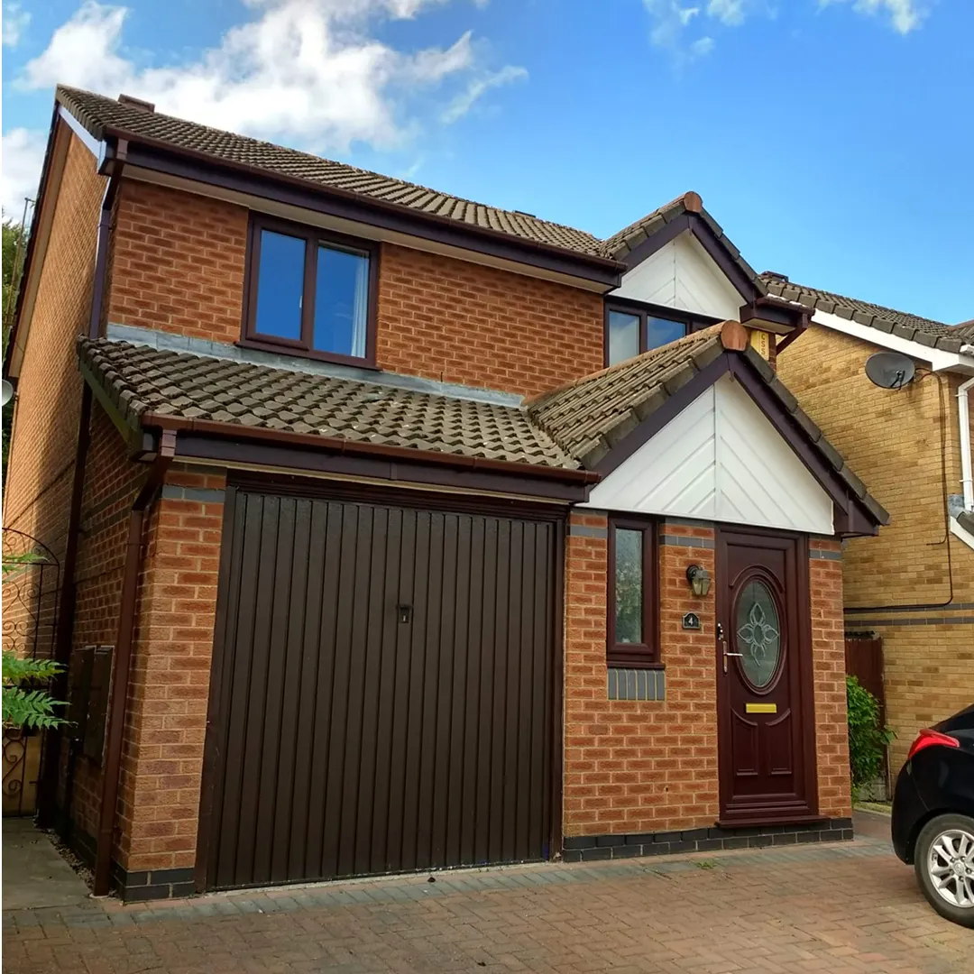 Replacement windows and front door on a red brick house